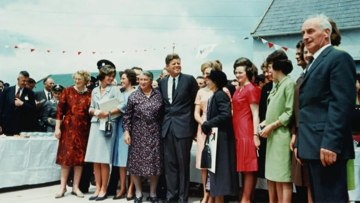 An archive photograph of President John F. Kennedy standing with members of his family and hosts during his 1963 visit to Ireland.